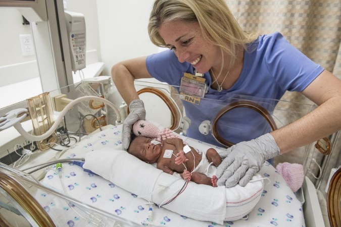 A nurse with a newborn baby